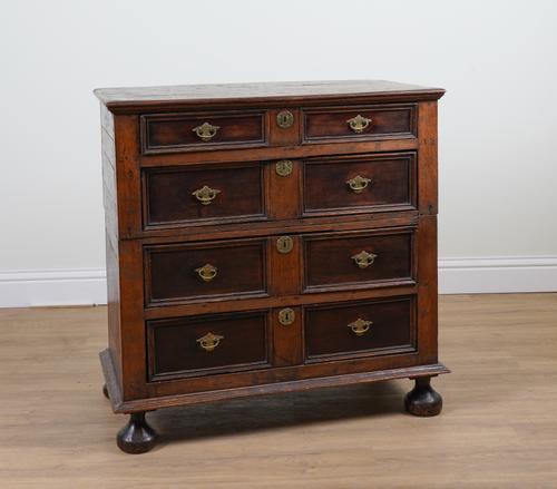 A CHARLES II OAK TWO PART FOUR DRAWER CHEST OF DRAWERS