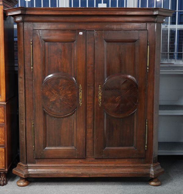 A 19TH CENTURY CONTINENTAL WALNUT TWO DOOR ARMOIRE