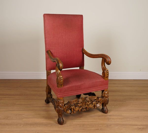 A 19TH CENTURY CARVED OAK SQUARE BACK OPEN ARMCHAIR