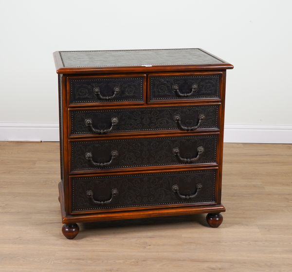 PROBABLY THEODORE ALEXANDER; AN EMBOSSED METAL VENEERED FIVE DRAWER CHEST OF DRAWERS