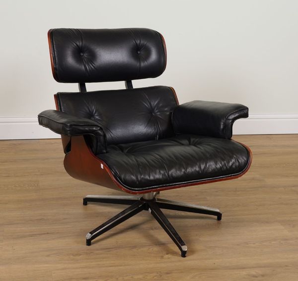 IN THE MANNER OF CHARLES EAMES; A STAINED LAMINATED PLYWOOD AND BLACK LEATHER UPHOLSTERED LOUNGE CHAIR