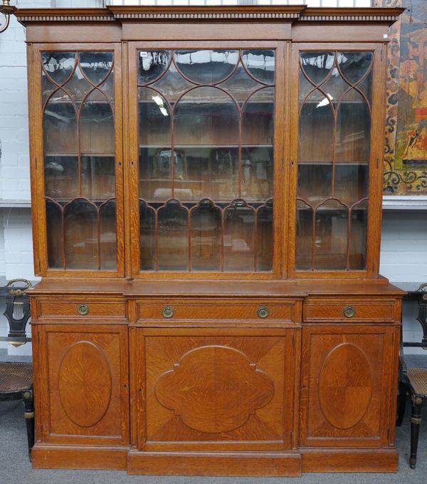 A 19TH CENTURY OAK BREAKFRONT BOOKCASE CABINET