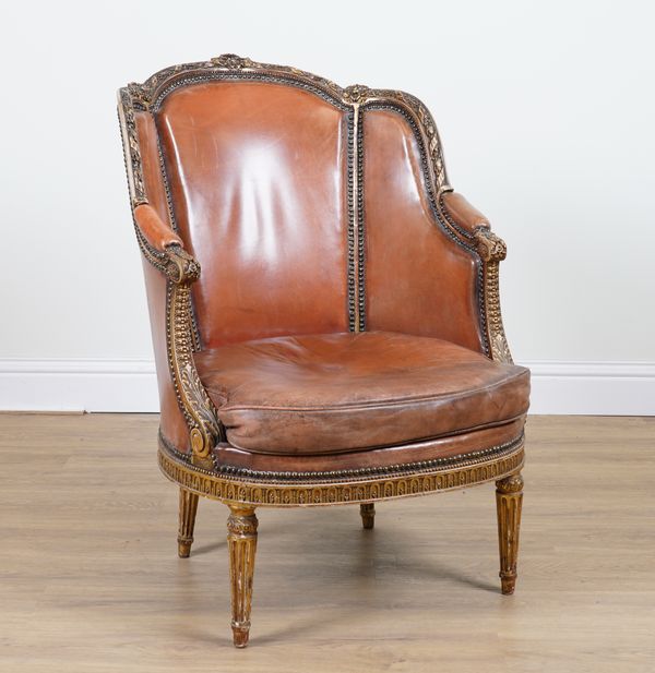 A LOUIS XVI STYLE BRASS STUDDED LEATHER UPHOLSTERED TUB BACK ARMCHAIR