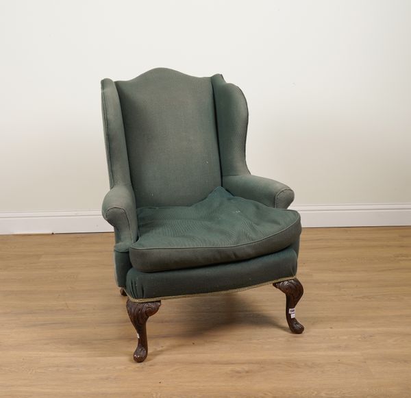 A GEORGE I STYLE WINGBACK ARMCHAIR ON CARVED WALNUT CABRIOLE SUPPORTS