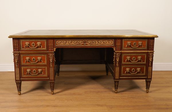 A LOUIS XVI STYLE GILT METAL MOUNTED MAHOGANY SEVEN DRAWER KNEEHOLE DESK