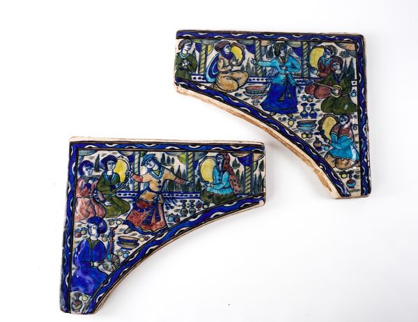 A PAIR OF QAJAR POTTERY TILE SPANDRELS (2)