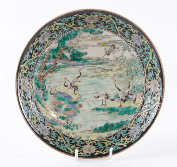 A CHINESE FAMILLE-NOIRE SAUCER DISH