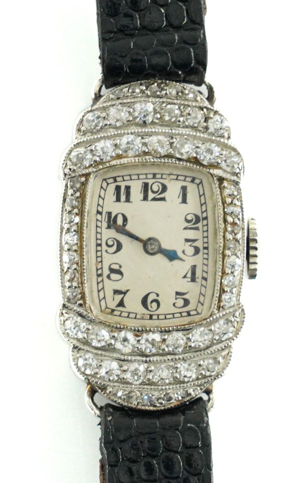 A SWISS LADIES PLATINUM AND DIAMOND SET MANUAL WIND COCKTAIL WATCH