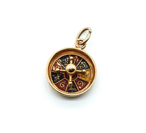 A GOLD  AND ENAMELLED ROULETTE CHARM