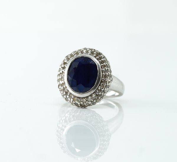 A WHITE GOLD, SAPPHIRE AND DIAMOND OVAL CLUSTER RING