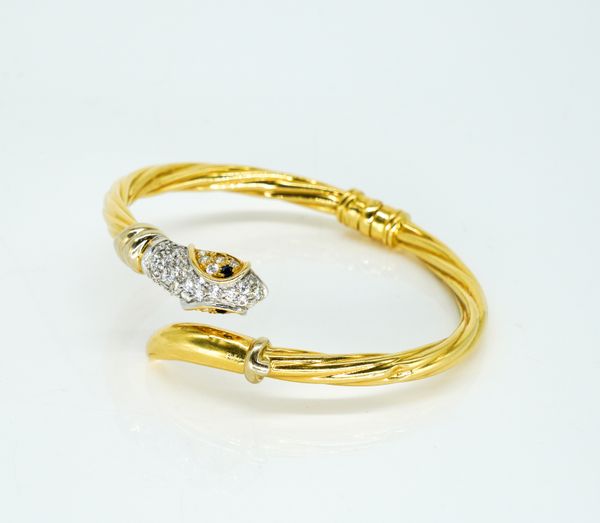 A GOLD, SAPPHIRE AND COLOURLESS GEM SET BANGLE