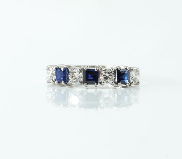 AN 18CT WHITE GOLD, SAPPHIRE AND DIAMOND SEVEN STONE HALF HOOP RING