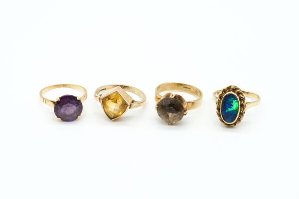 FOUR GOLD AND GEM SET SOLITAIRE RINGS (4)