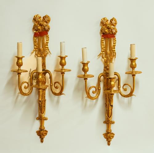 A PAIR OF LOUIS XVI STYLE GILT-METAL THREE LIGHT WALL APPLIQUÉS (2)