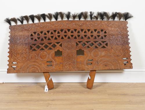 A PROCESSIONAL RELIEF CARVED AND PIERCED HARDWOOD PANEL IN THE FORM OF AN OX YOKE