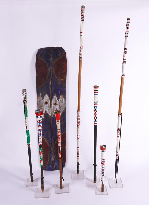A GROUP OF SEVEN CEREMONIAL STAFFS AND SPEARS TOGETHER WITH A PAINTED SHIELD (8)