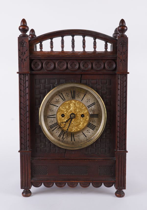 A VICTORIAN AESTHETIC MAHOGANY MANTEL CLOCK