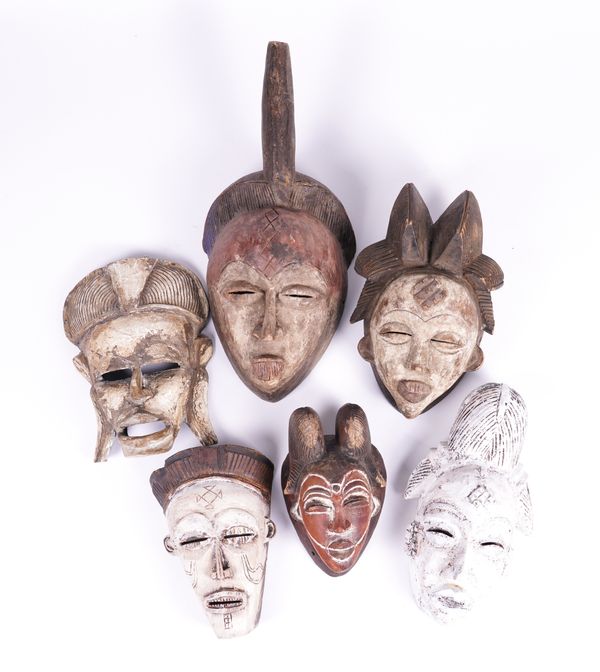 A GROUP OF PAINTED AFRICAN, SOME POSSIBLY PUNU, TRIBAL MASKS (6)