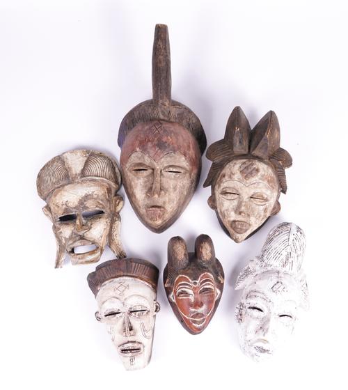 A GROUP OF PAINTED AFRICAN, SOME POSSIBLY PUNU, TRIBAL MASKS (6)