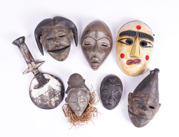 TWO AFRICAN TRIBAL, POSSIBLY OGONI (NIGERIA), MASKS AND A GROUP OF OTHER TRIBAL ITEMS (7)