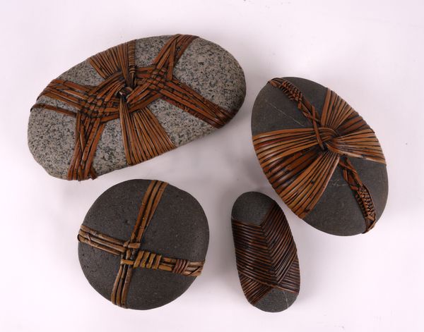 A GROUP OF FOUR WICKER OR CANE WRAPPED STONES (4)