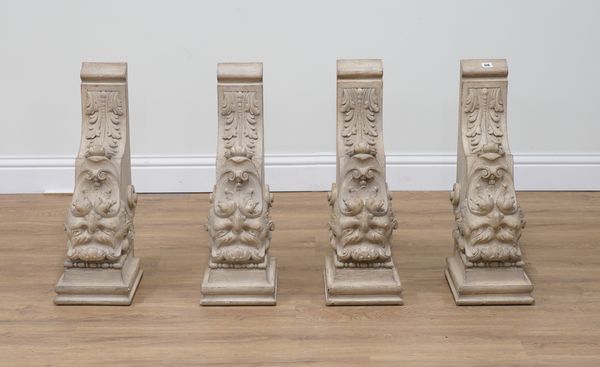 A PAIR OF CREAM PAINTED WOODEN WALL BRACKETS RELIEF CARVED WITH GROTESQUE MASKS (4)