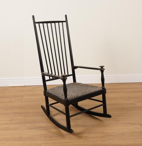 KARL AXEL ADOLFSSON FOR GEMLA RETAILED BY HEAL’S; A MID 20TH CENTURY EBONISED STICK BACK ROCKING CHAIR