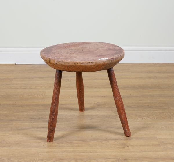 A 19TH CENTURY PRIMITIVE CIRCULAR ELM OCCASIONAL TABLE ON THREE STAKED ASH SUPPORTS