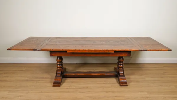 A 17TH CENTURY STYLE CLEATED OAK PLANK TOP DRAW-LEAF EXTENDING DINING TABLE