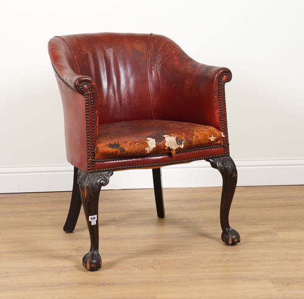 A GEORGE III STYLE STUDDED ROUGE LEATHER UPHOLSTERED TUB BACK CHAIR ON CLAW AND BALL SUPPORTS