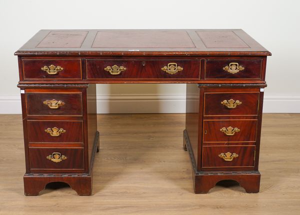 A SMALL MAHOGANY NINE DRAWER PEDESTAL DESK