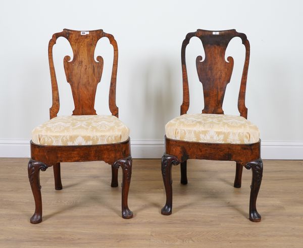 A PAIR OF EARLY 18TH CENTURY/QUEEN ANNE WALNUT FRAMED VASE BACK DINING CHAIRS ON SHELL CAPPED PAD FEET (2)