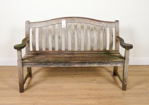A HARDWOOD SHAPED BACK GARDEN BENCH