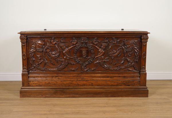 AN 18TH CENTURY ITALIAN WALNUT CASSONE WITH EXTENSIVELY CARVED FRONT PANEL