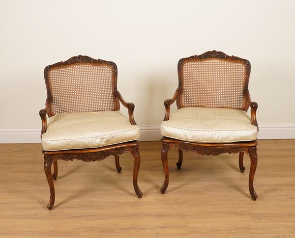 A PAIR OF LOUIS XV STYLE CARVED STAINED BEECH CANEWORK OPEN ARMCHAIRS