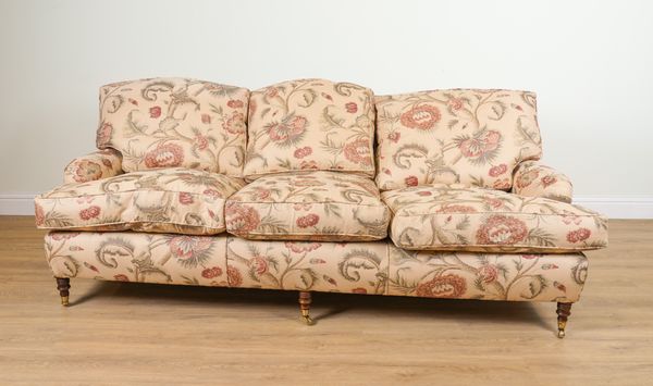 A MODERN FLORAL BEIGE UPHOLSTERED THREE SEAT SOFA