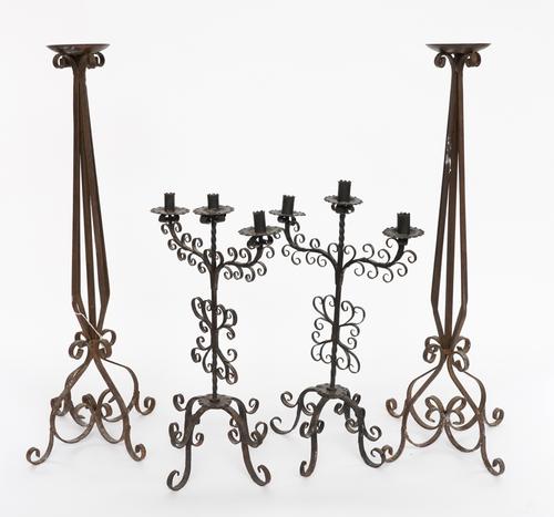 A PAIR OF WROUGHT-IRON PRICKET CANDLESTICKS AND A PAIR OF THREE LIGHT CANDELABRA (4)
