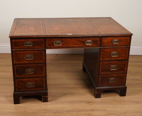 BAKER FURNITURE; A MAHOGANY AND YEW WOOD NINE DRAWER PEDESTAL DESK