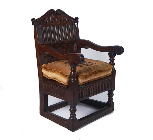 A 17TH CENTURY OAK OPEN ARMCHAIR