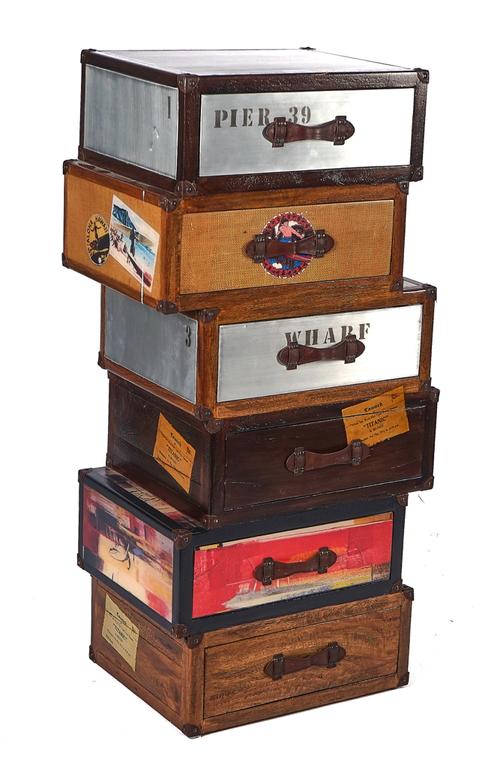 A MODERN CHEST OF SIX DRAWERS FORMED AS IRREGULAR STACKED TRAVEL TRUNKS