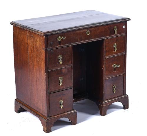 A GEORGE III OAK KNEE-HOLE DESK