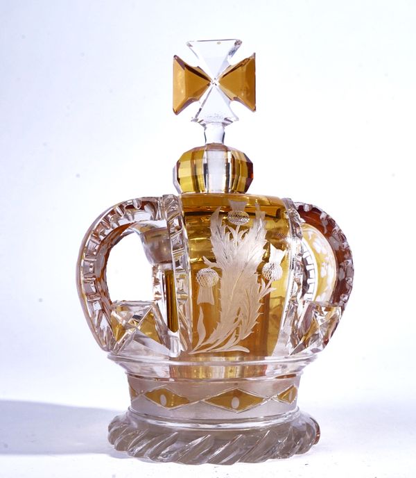 AN AMBER FLASH AND CUT GLASS OPENWORK CROWN SCENT BOTTLE AND STOPPER