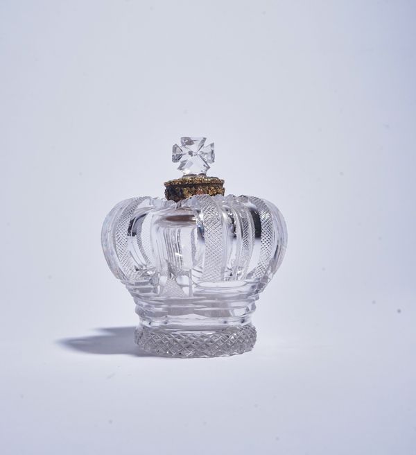 A RARE GILT-METAL MOUNTED CUT GLASS OPENWORK CROWN SCENT BOTTLE AND STOPPER (2)