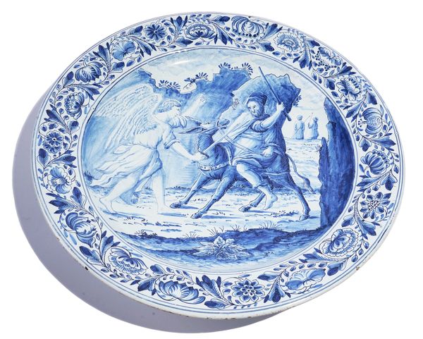A CONTINENTAL TINGLAZED EARTHENWARE BLUE AND WHITE DISH