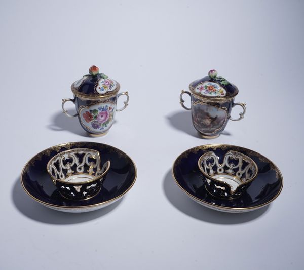 A PAIR OF MEISSEN BLUE- GROUND CHOCOLATE CUPS, COVERS AND TREMBLEUSE SAUCERS (6)
