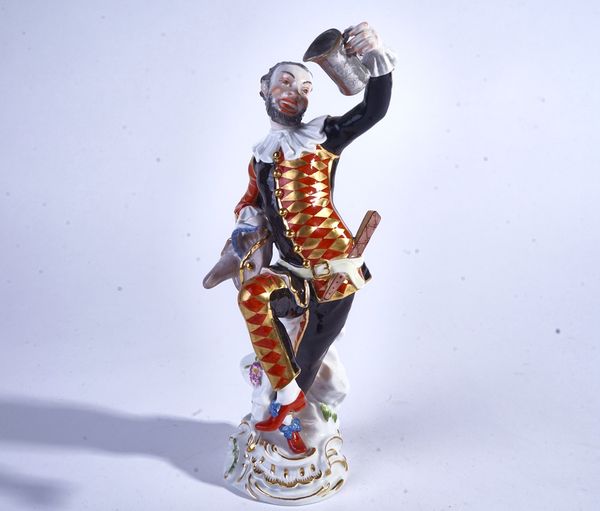 A MEISSEN FIGURE OF THE DANCING HARLEQUIN WITH A MUG