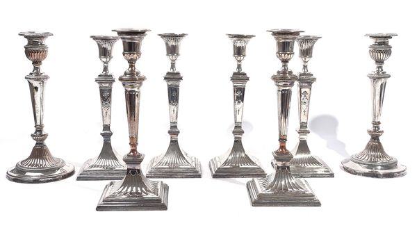 A SET OF FOUR SILVER PLATED ON COPPER TABLE CANDLESTICKS AND TWO FURTHER PAIRS OF CANDELSTICKS (8)
