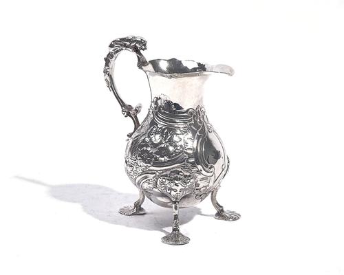 A LATE GEORGE II SILVER CREAM JUG