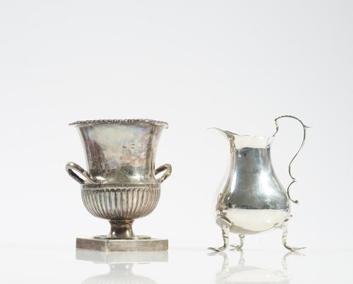 A SILVER VASE AND A SILVER CREAM JUG (2)