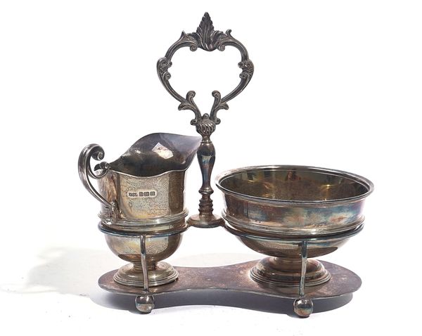 A SILVER SUGAR AND CREAM SET WITH A STAND (3)